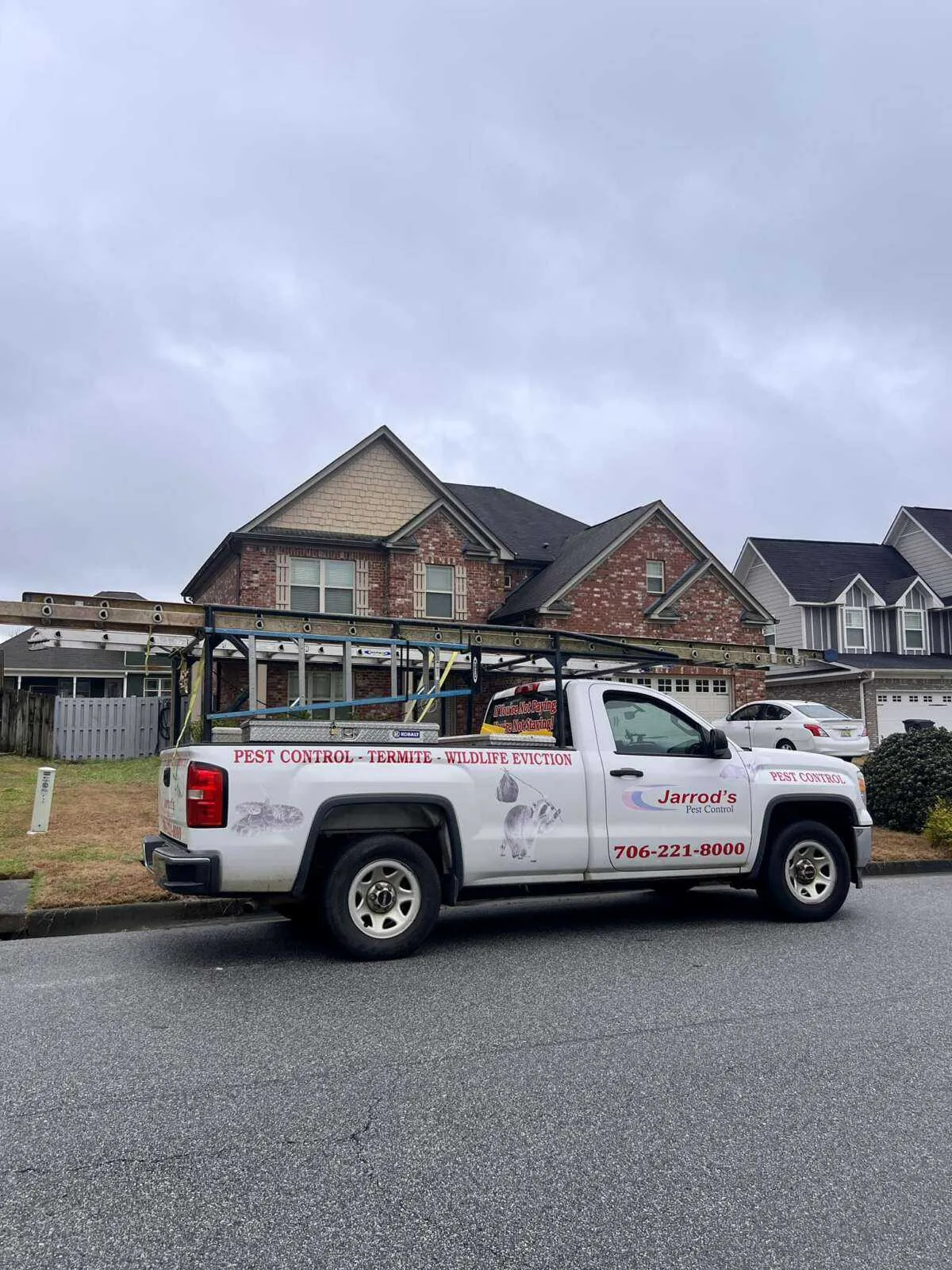 Jarrod's Pest Control truck parked outside a Columbus home